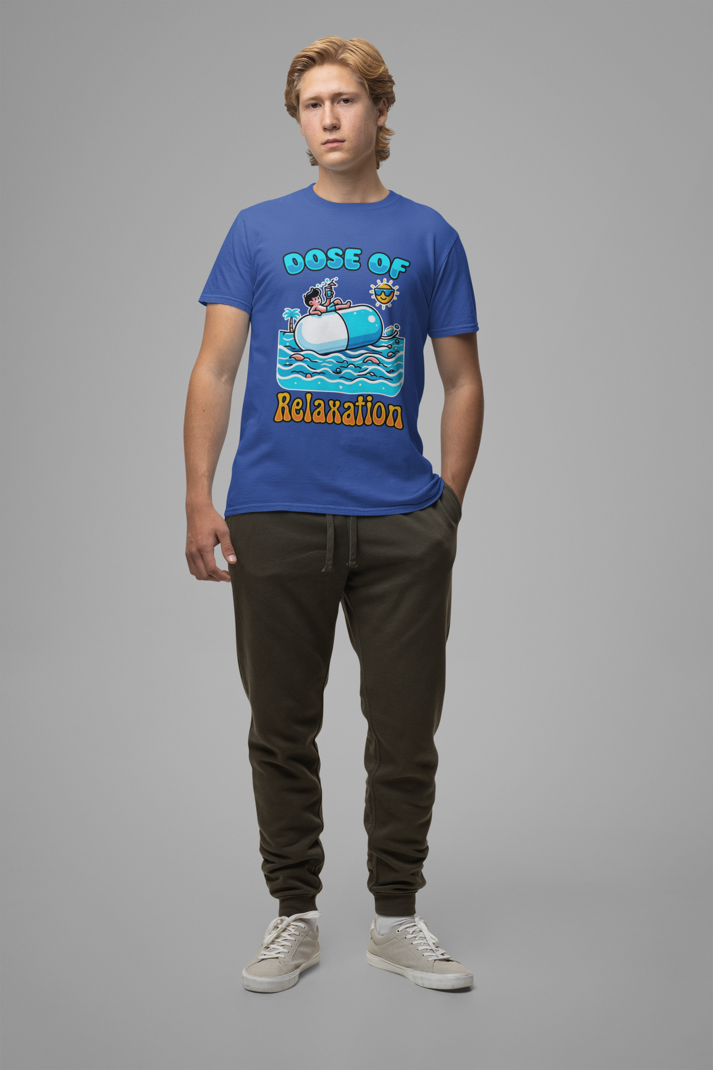 Dose of Relaxation | Boy Sitting on Pill Floating on Water with Drink, Sun & Palm Tree Graphic T-Shirt