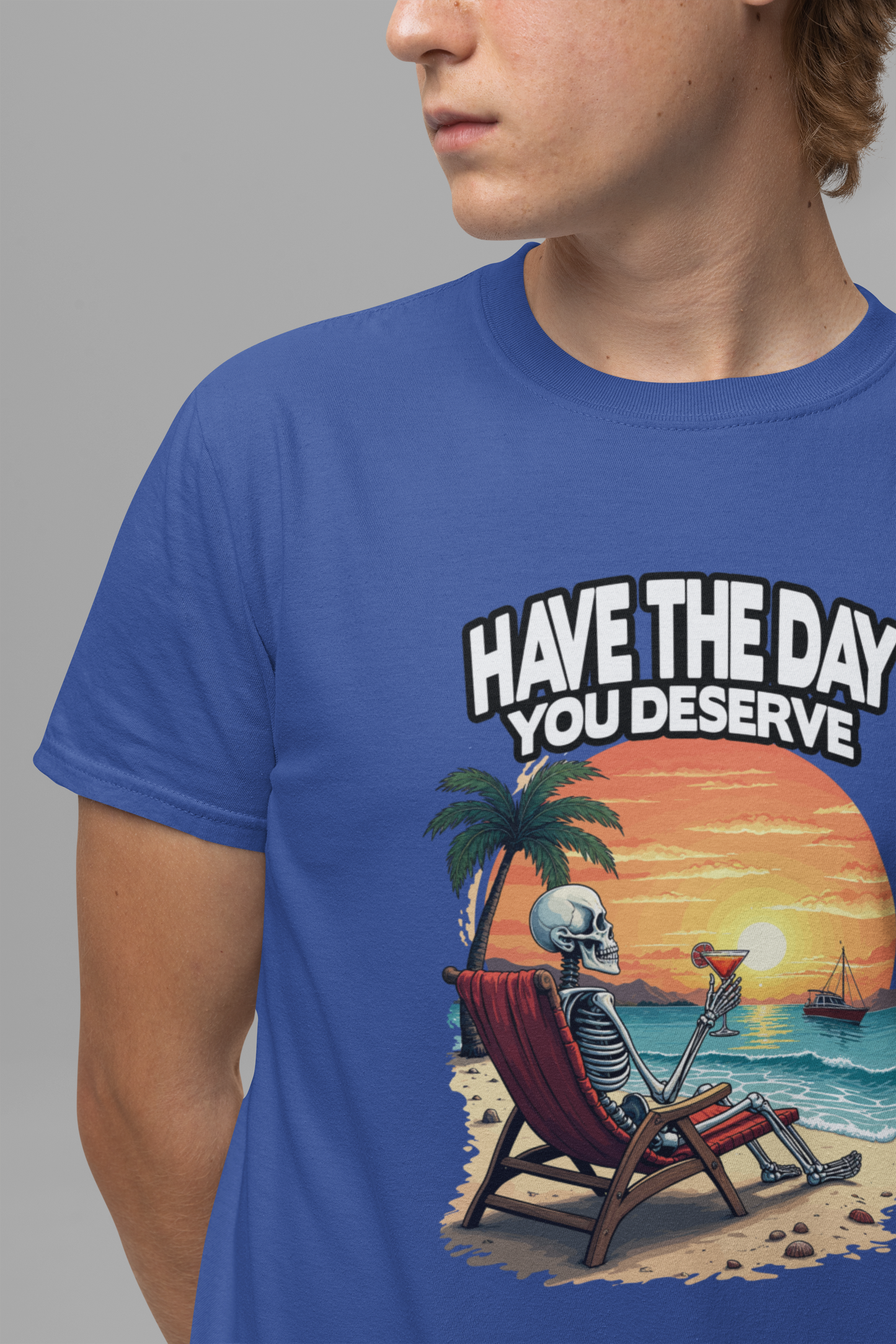 Have the Day You Deserve Tshirt – Relaxing Skeleton with Drink on Beach Sunset